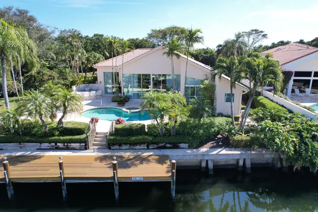 a view of house with yard outdoor seating and lake view