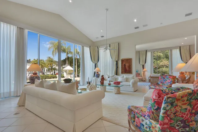 a living room with furniture a rug and a chandelier