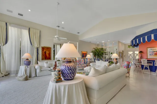 a living room with furniture a rug and white walls