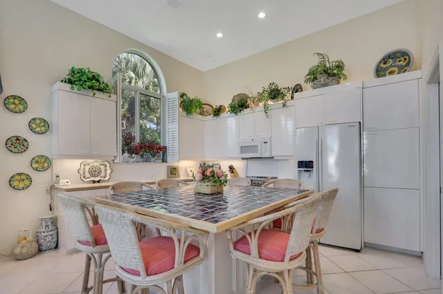 a kitchen with kitchen island a counter space a sink and cabinets