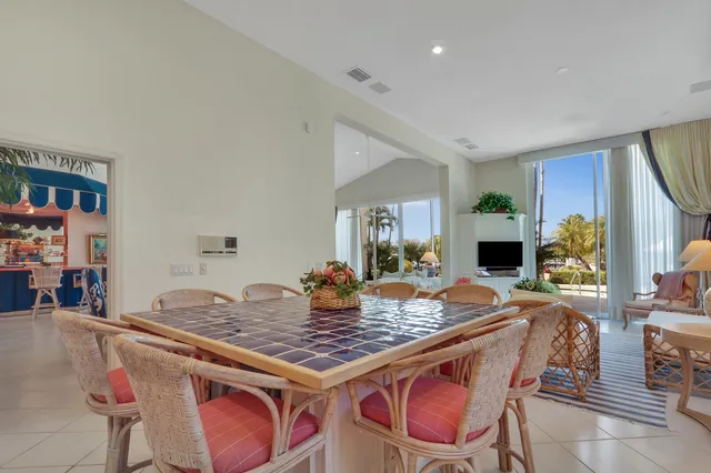 a view of a dining room with furniture large window and wooden floor