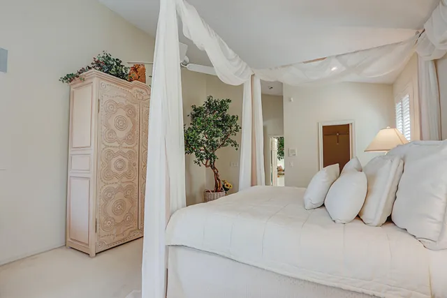 a large white bathroom with a granite countertop sink a mirror and a bathtub