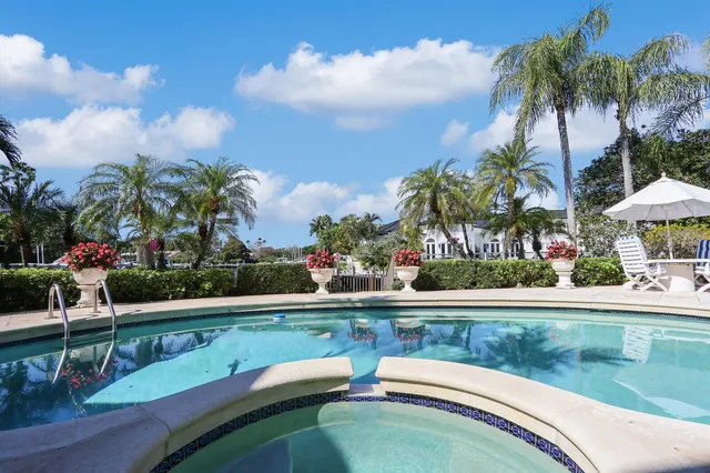 a view of a house with swimming pool and sitting area