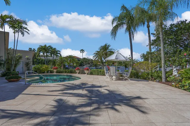 a view of a house with a yard and potted plants
