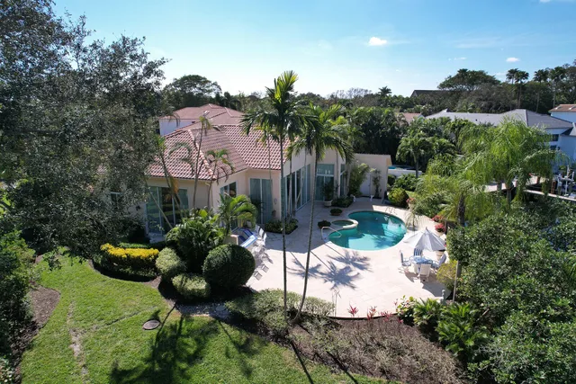 an aerial view of a houses with a swimming pool