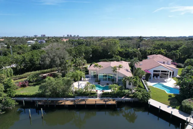 a balcony with wooden floor table and chairs