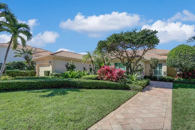 a view of a house with a big yard and potted plants