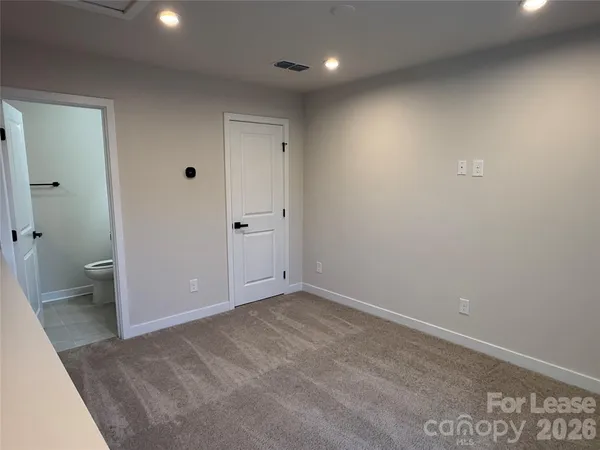 a bathroom with a sink toilet and mirror