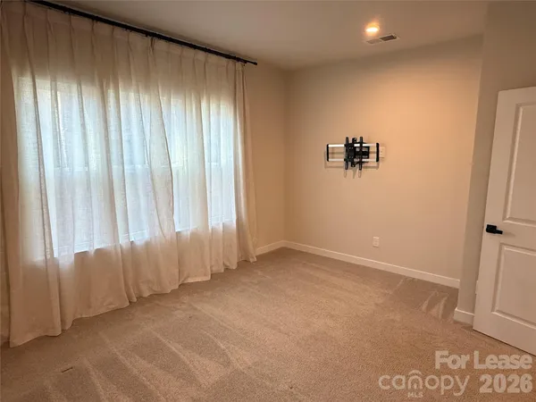 a view of an empty room with a bathroom