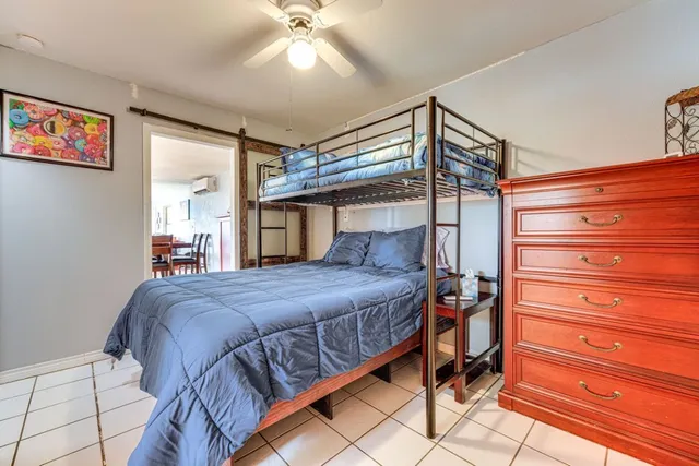 a bedroom with a bed and a chandelier