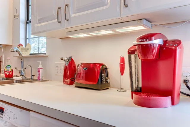 a kitchen with stainless steel appliances granite countertop a sink and a refrigerator