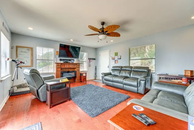 a living room with furniture a fireplace and a flat screen tv