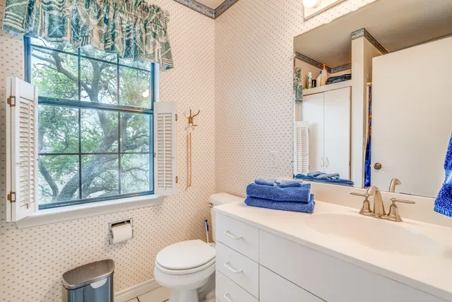 a bathroom with a double vanity sink toilet and a mirror