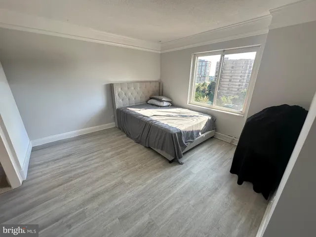 a bedroom with two beds and a chair