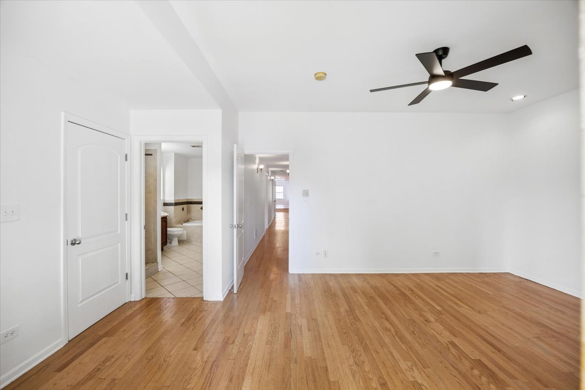 2363 East 70th Street, Unit 1 Chicago, IL 60649 - Photo 17 of 26 a view of a room with wooden floor and a ceiling fan