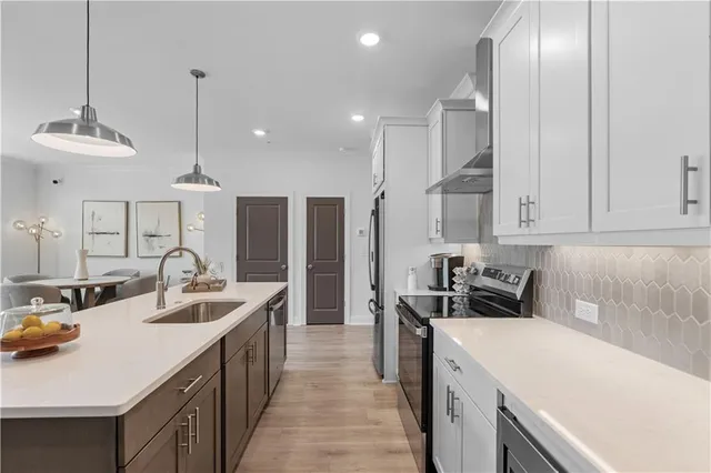 a kitchen with counter top space a sink stainless steel appliances and cabinets