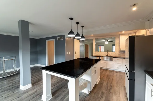 a kitchen with a sink and a refrigerator