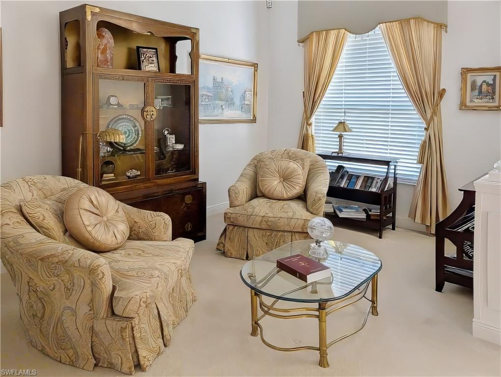5758 Lago Villaggio Way Naples, FL 34104 - Photo 11 of 42 Living area with light carpet