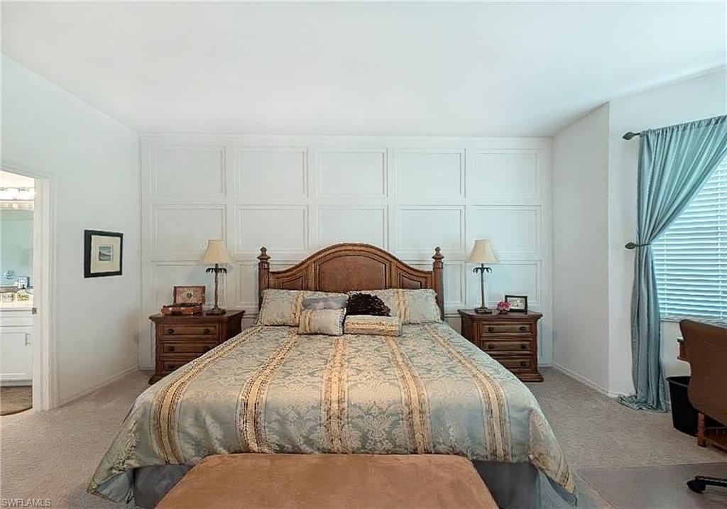 5758 Lago Villaggio Way Naples, FL 34104 - Photo 26 of 42 Bedroom with light colored carpet