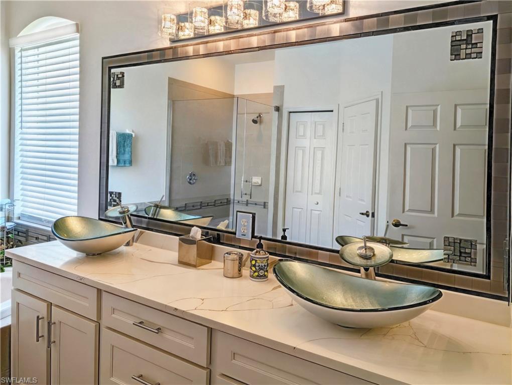 5758 Lago Villaggio Way Naples, FL 34104 - Photo 29 of 42 Master Bathroom featuring vanity and walk in shower