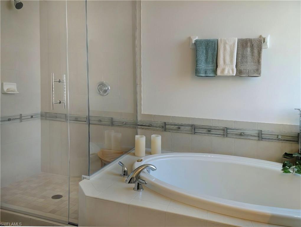 5758 Lago Villaggio Way Naples, FL 34104 - Photo 30 of 42 Bathroom featuring shower with separate bathtub