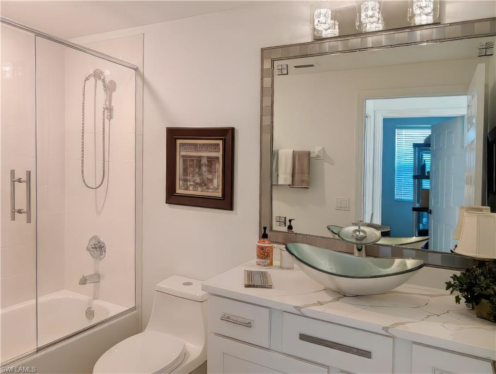 5758 Lago Villaggio Way Naples, FL 34104 - Photo 36 of 42 Guest bath / shower combo with glass door