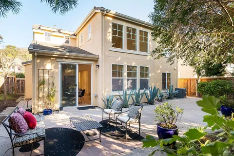 an aerial view of a house with a yard and sitting area