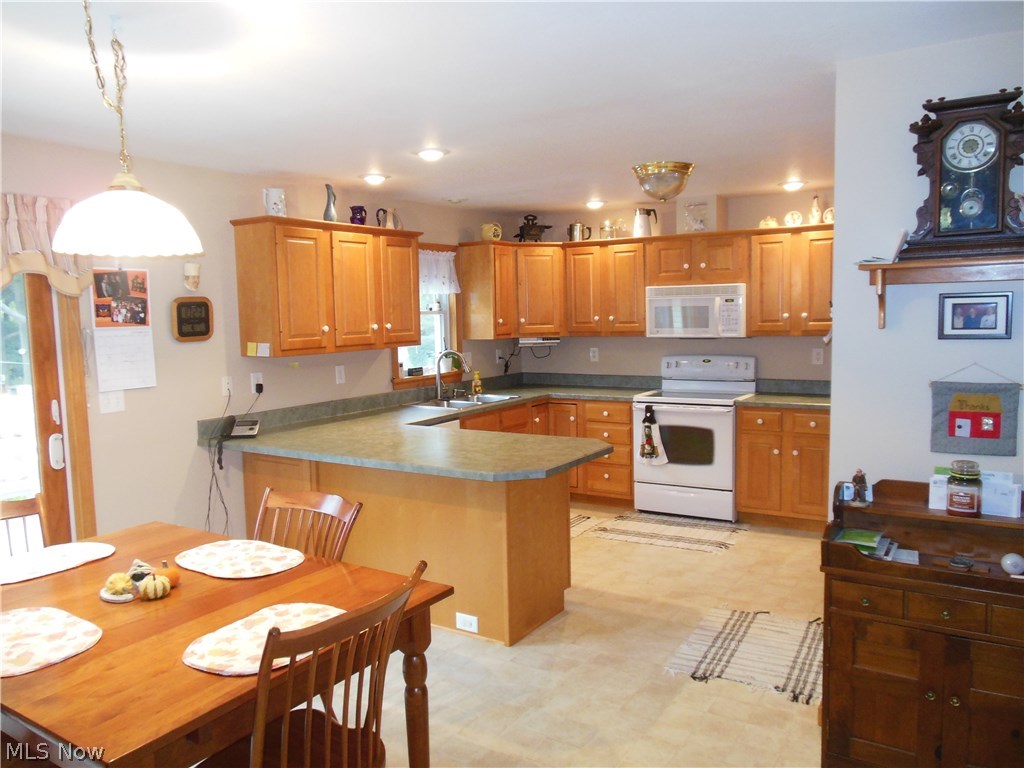 2499 Haines Road Madison, OH 44057 - Photo 10 of 29 Kitchen with Breakfast Bar, loads of Cabinets & Appliances.
