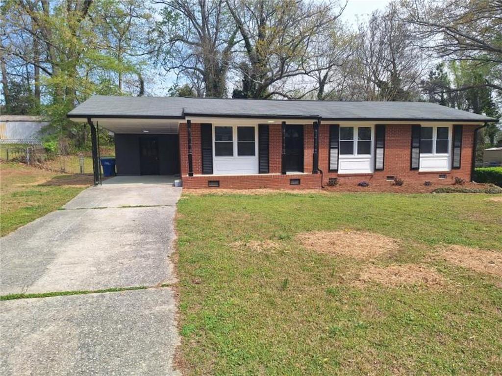 5370 Longmeadow Lane Atlanta, GA 30349 - Photo 1 of 13 a front view of a house with a garden and porch