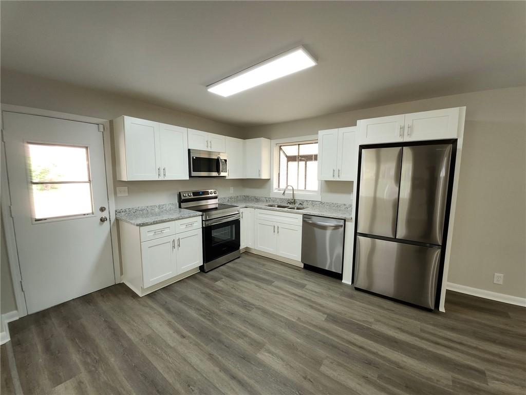 5370 Longmeadow Lane Atlanta, GA 30349 - Photo 2 of 13 a kitchen with granite countertop stainless steel appliances a refrigerator sink and microwave