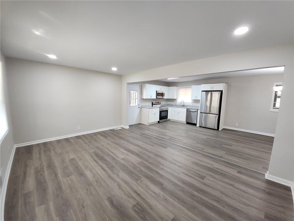 5370 Longmeadow Lane Atlanta, GA 30349 - Photo 5 of 13 a view of empty room with wooden floor