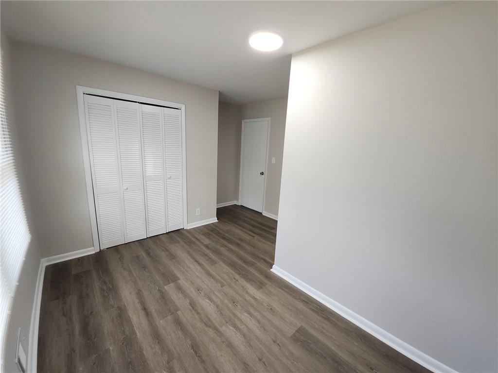 5370 Longmeadow Lane Atlanta, GA 30349 - Photo 8 of 13 a view of an empty room with wooden floor