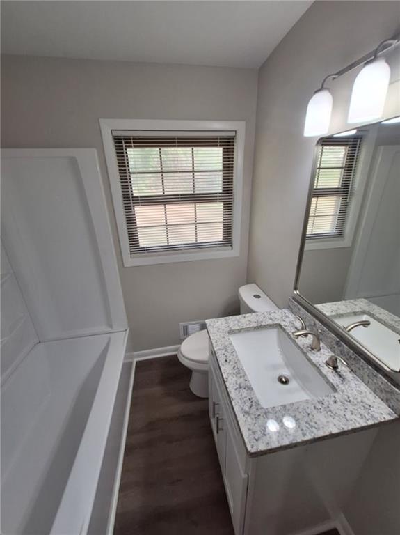 5370 Longmeadow Lane Atlanta, GA 30349 - Photo 9 of 13 a bathroom with a granite countertop sink a toilet and mirror