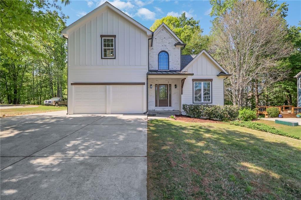 6259 Spring Lake Drive Flowery Branch, GA 30542 - Photo 35 of 35 a front view of a house with a yard and garage