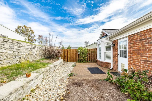 a view of a backyard with pathway