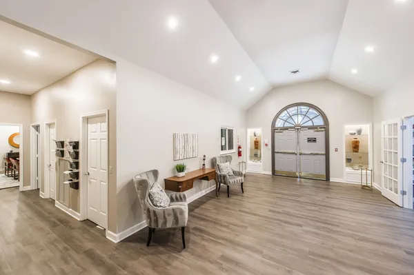 a living room with furniture and a clock
