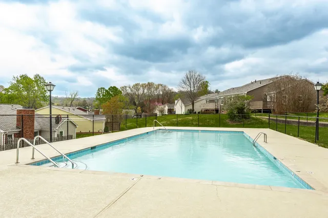 a view of a swimming pool and a yard