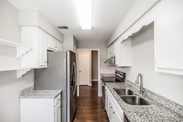 a kitchen with a sink stove and refrigerator