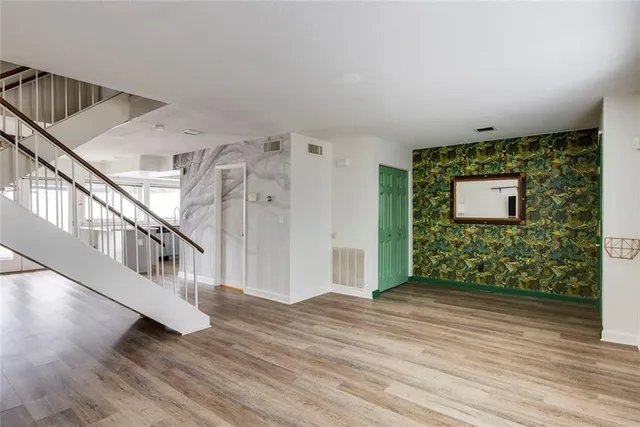 a kitchen with stainless steel appliances kitchen island granite countertop a refrigerator and a sink