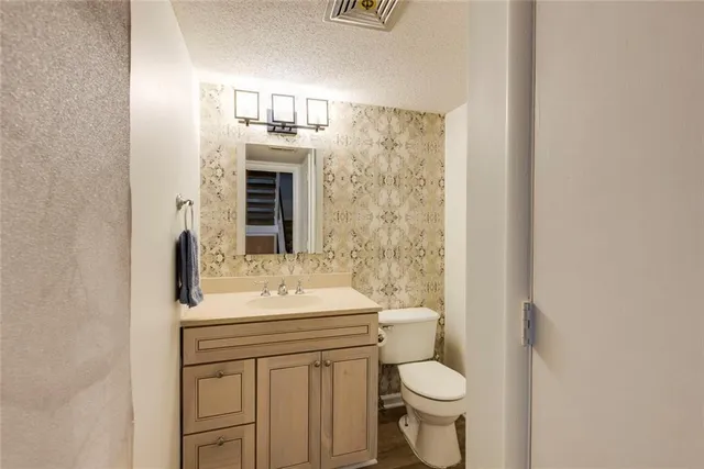 a view of a kitchen with a sink wooden floor and cabinets