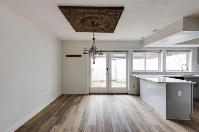 a view of a room with wooden floor and window
