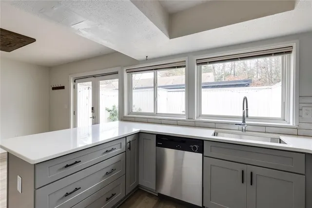 a kitchen with a refrigerator sink and cabinets
