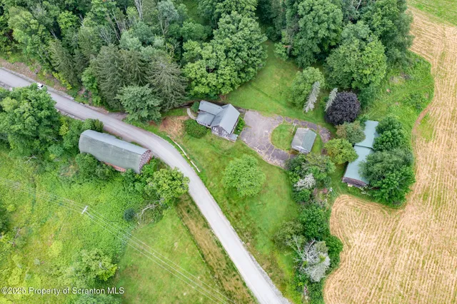 an aerial view of a house with a yard
