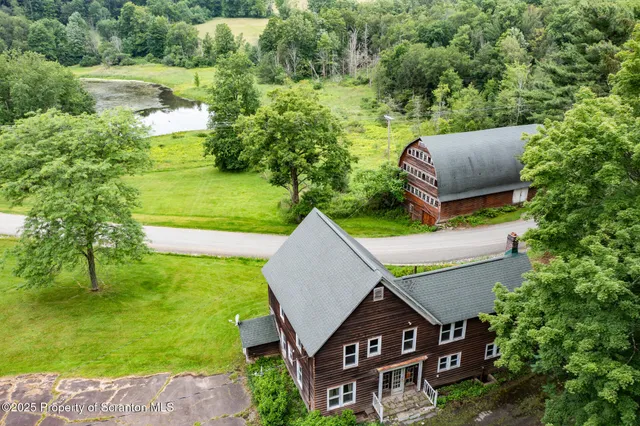 an aerial view of a house with a yard