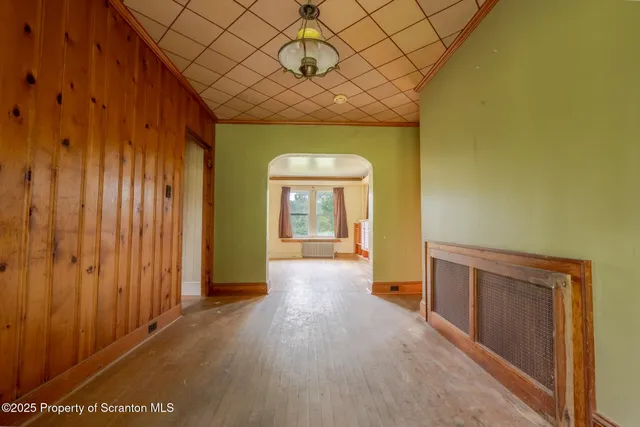 wooden floor in a hall with a window