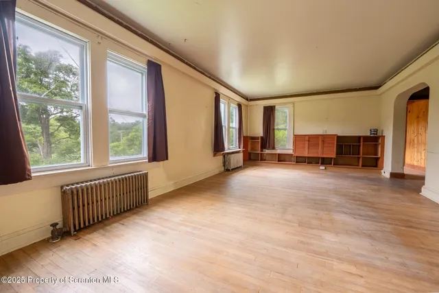 a view of a livingroom with furniture and staircase