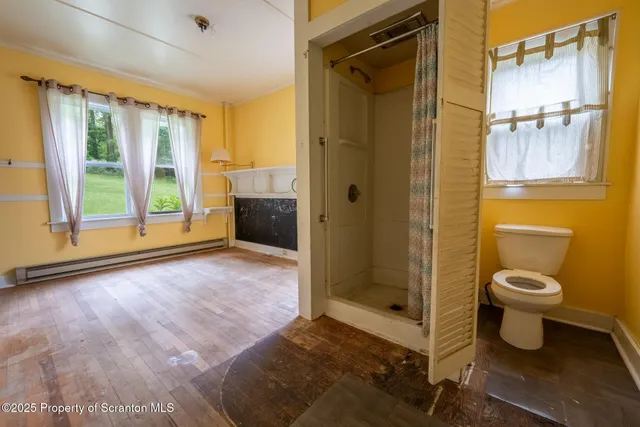 a spacious bathroom with a granite countertop sink toilet and shower