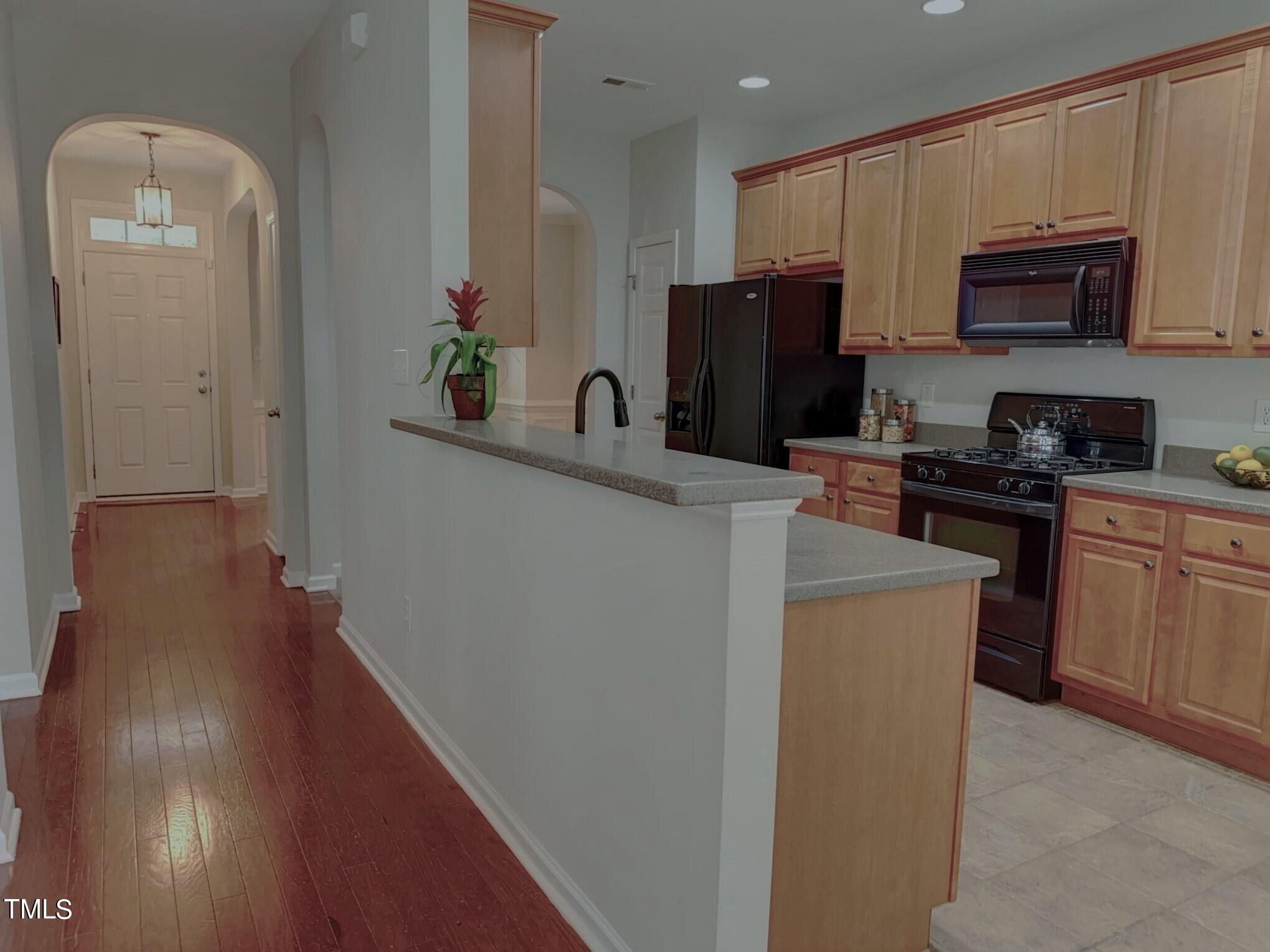 7608 Morrell Lane Durham, NC 27713 - Photo 11 of 34 a kitchen with a sink a stove and refrigerator