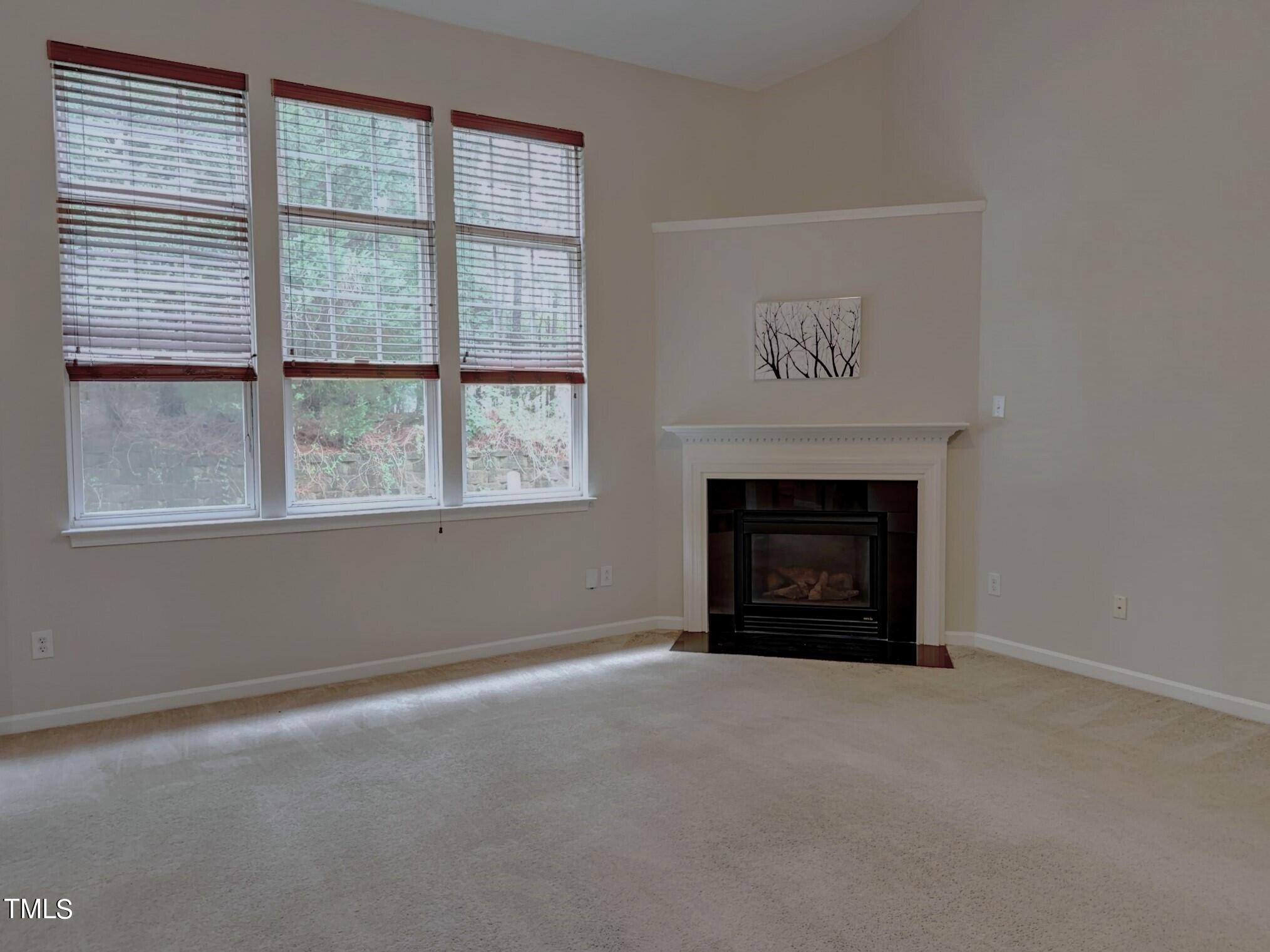 7608 Morrell Lane Durham, NC 27713 - Photo 14 of 34 an empty room with a fireplace