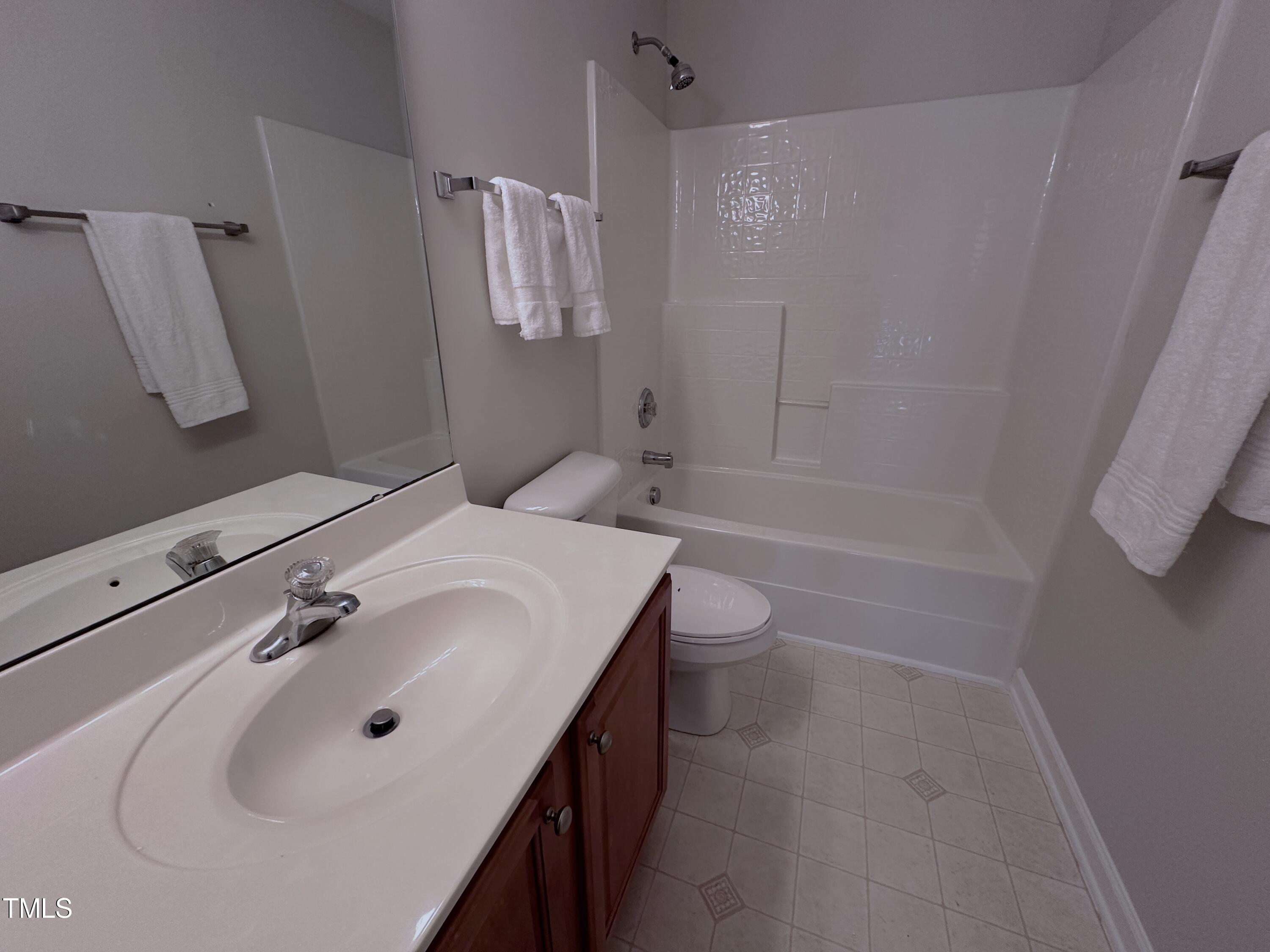 7608 Morrell Lane Durham, NC 27713 - Photo 25 of 34 a bathroom with a sink a toilet and shower